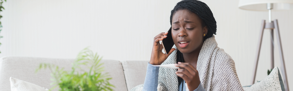 woman on the phone concerned with a fever